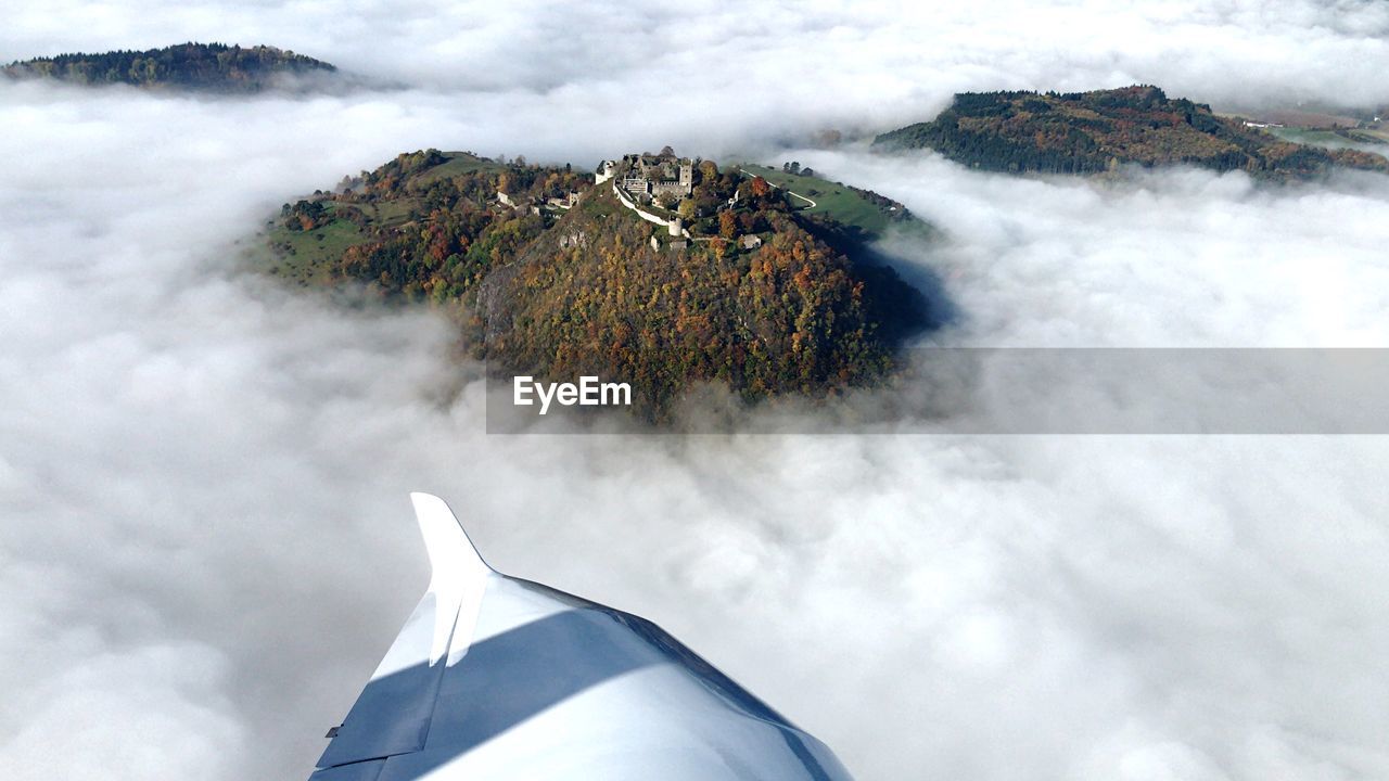 Aerial view of mountain amidst clouds