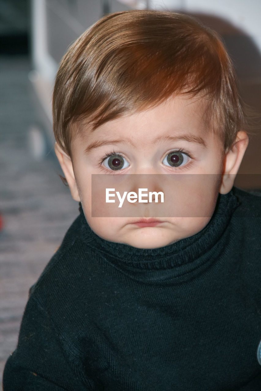 Little cute boy, big eyes, black sweater