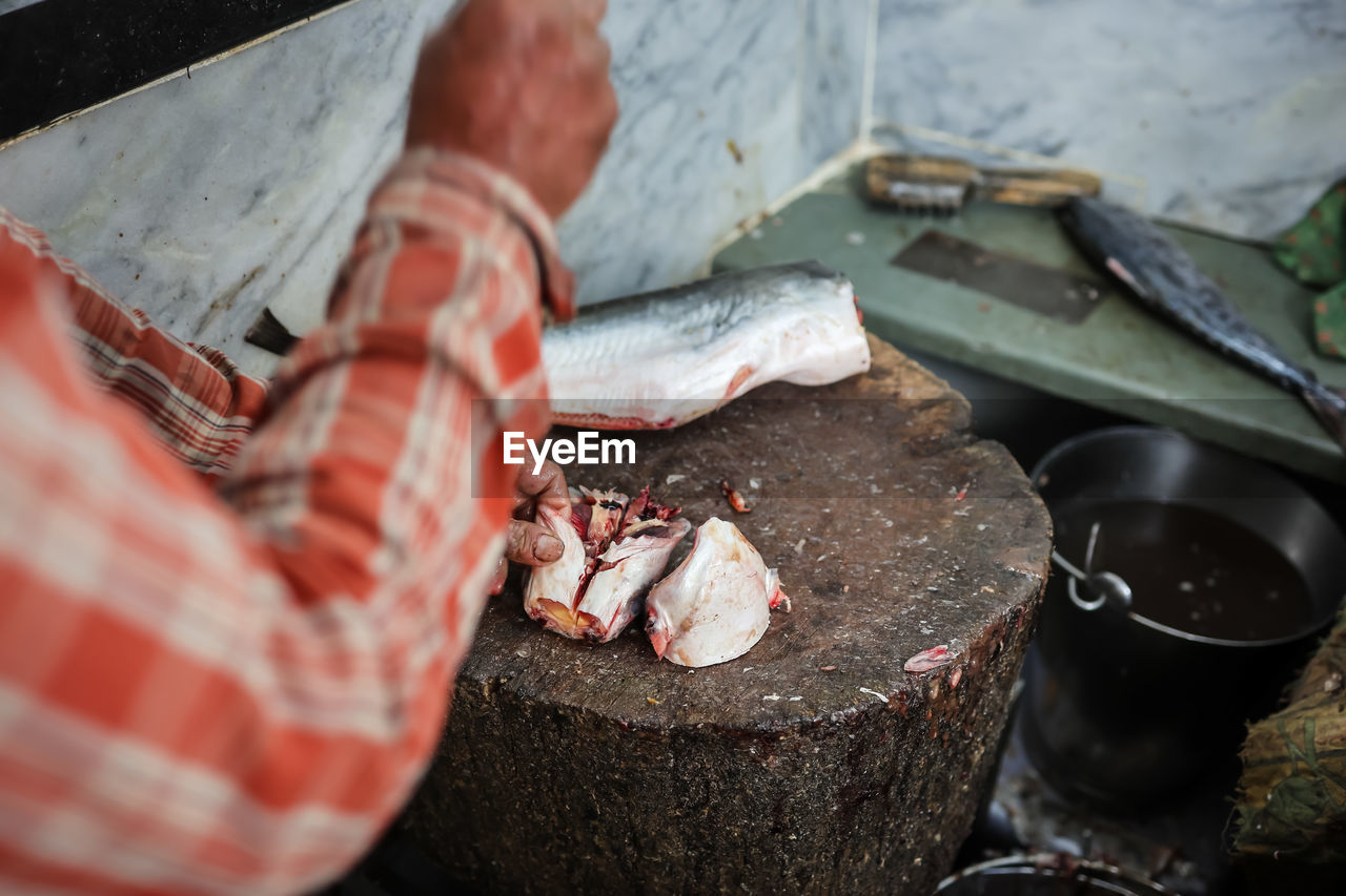 Fresh fish cutting at retail shop for sale at day from different angle