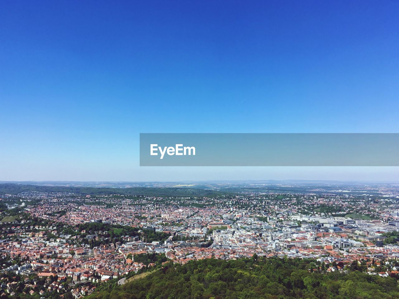 High angle view of cityscape against blue sky