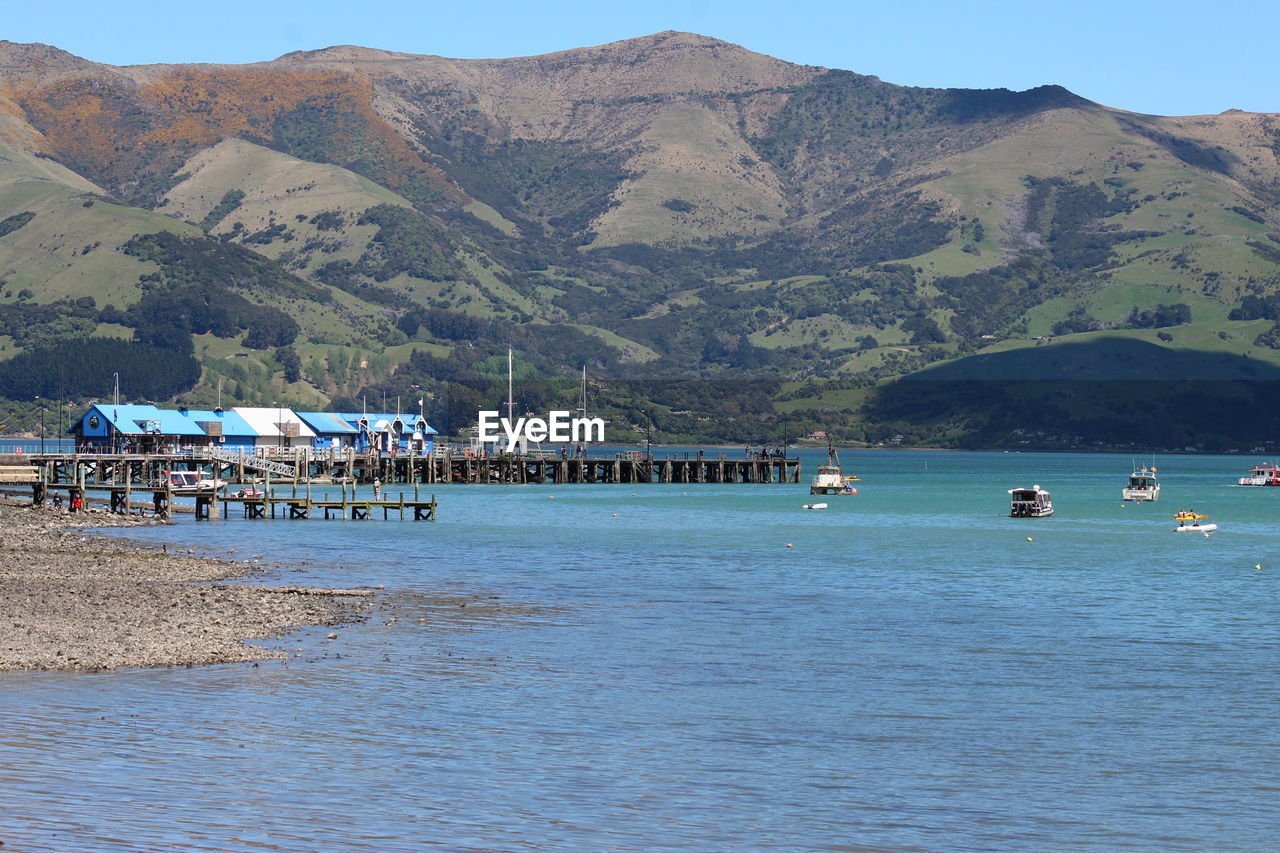 Scenic view of sea and mountains against sky