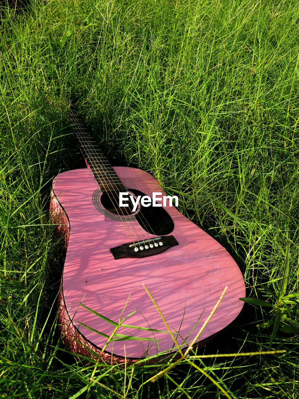 High angle view of guitar on field