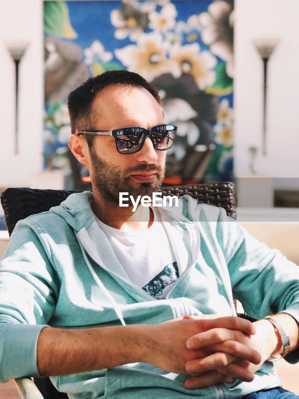 Man wearing sunglasses while sitting outdoors