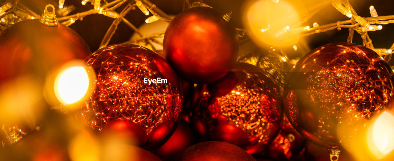 holiday, celebration, christmas decoration, christmas, decoration, christmas tree, christmas ornament, illuminated, no people, light, shiny, tradition, gold, food and drink, event, christmas lights, red, night, food, tree, close-up, lighting equipment, large group of objects, indoors, fruit, hanging, backgrounds