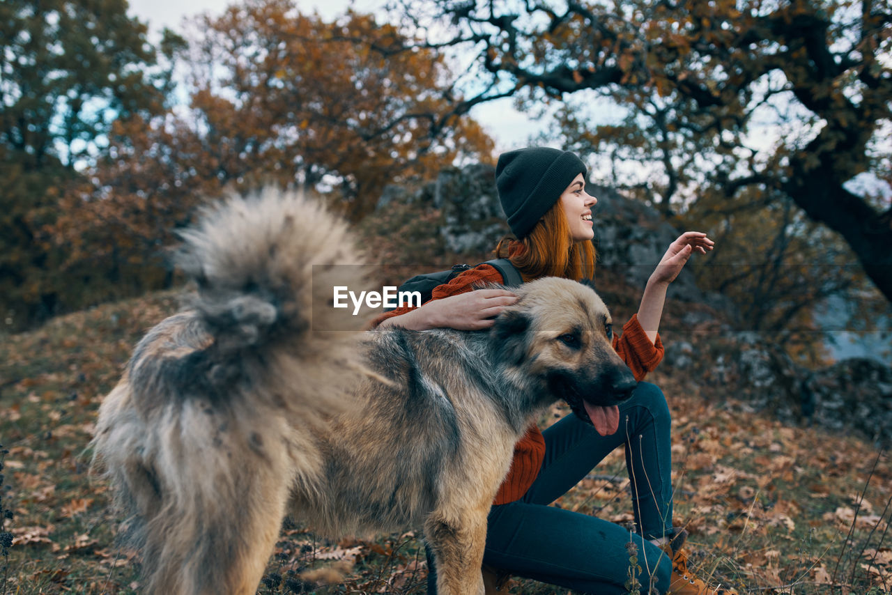 Full length of man with dog against trees