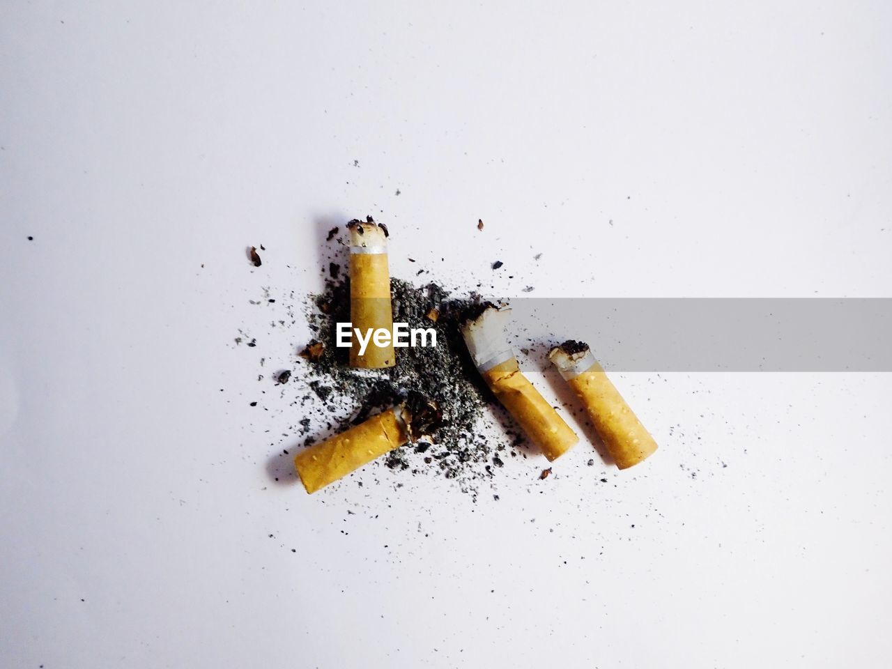 Close-up of cigarette smoking against white background