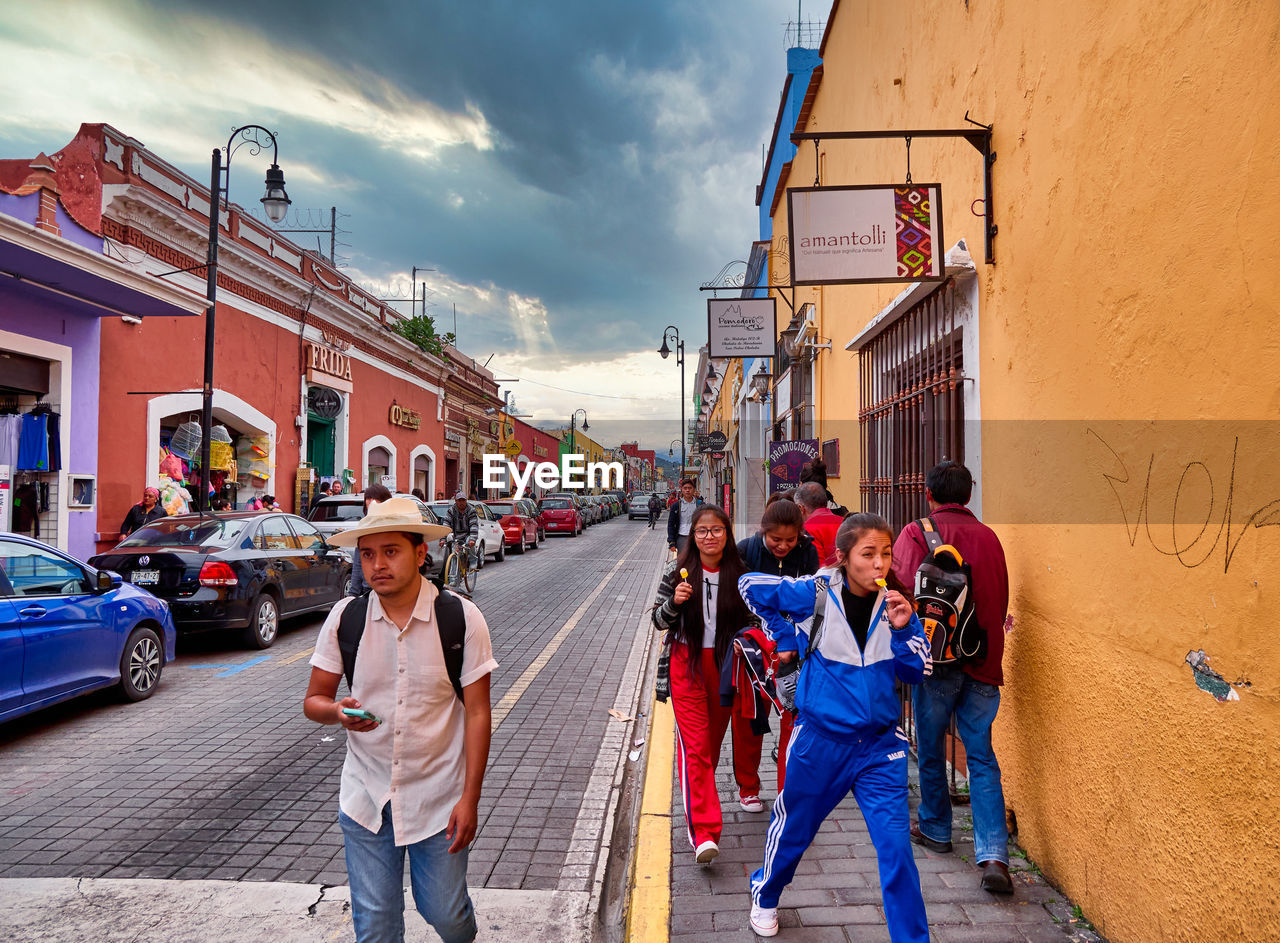 PEOPLE STANDING ON STREET IN CITY