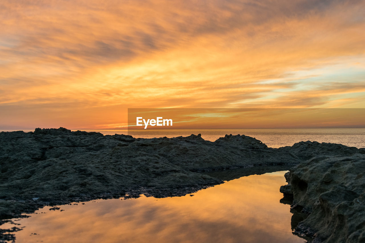 Scenic view of sea against sky during sunset