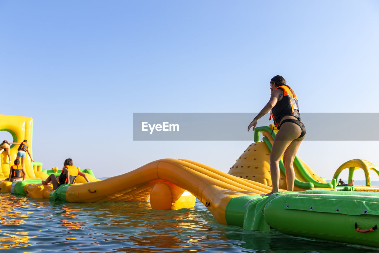 Inflatable bounce castle floats in park for children having fun in water with attractions in the sea