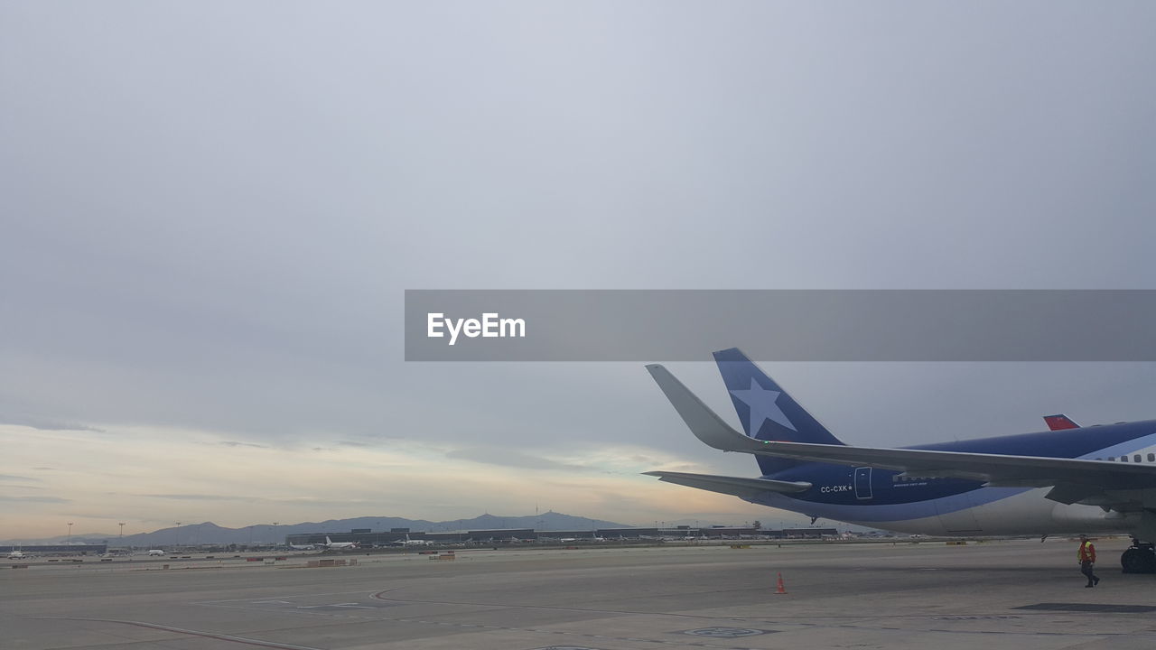 AIRPLANE ON RUNWAY AGAINST SKY