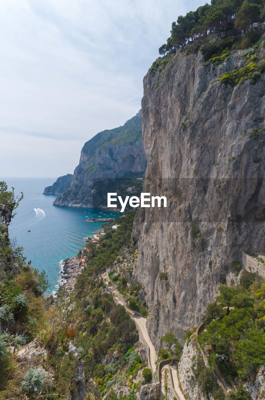 Scenic view of sea and mountains against sky