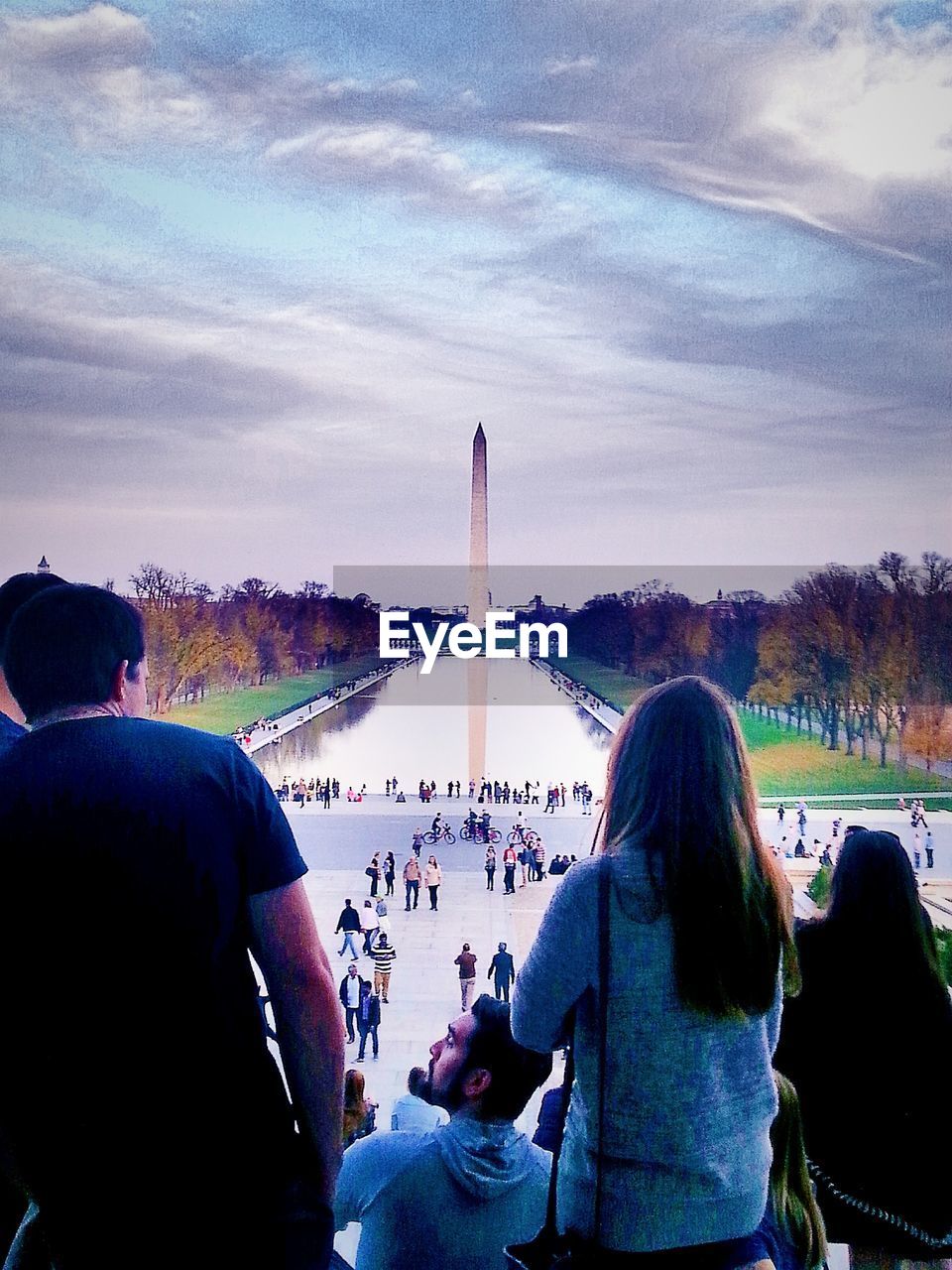 People at lincoln memorial looking at washington monument against sky