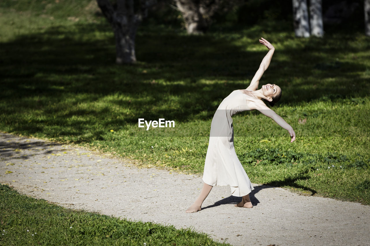 Full length of woman dancing at park