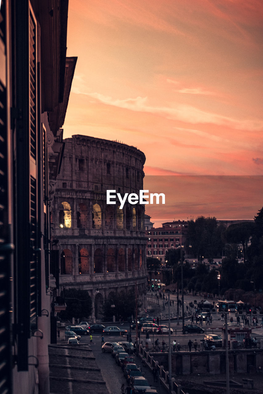 View of the colosseum from the window at sunset. rome, italy.