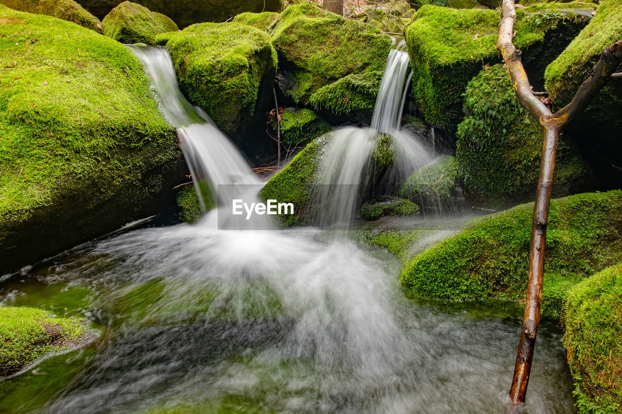 Beautiful waterfall with clear water on a mountain stream in the forest. breathing of rain forest