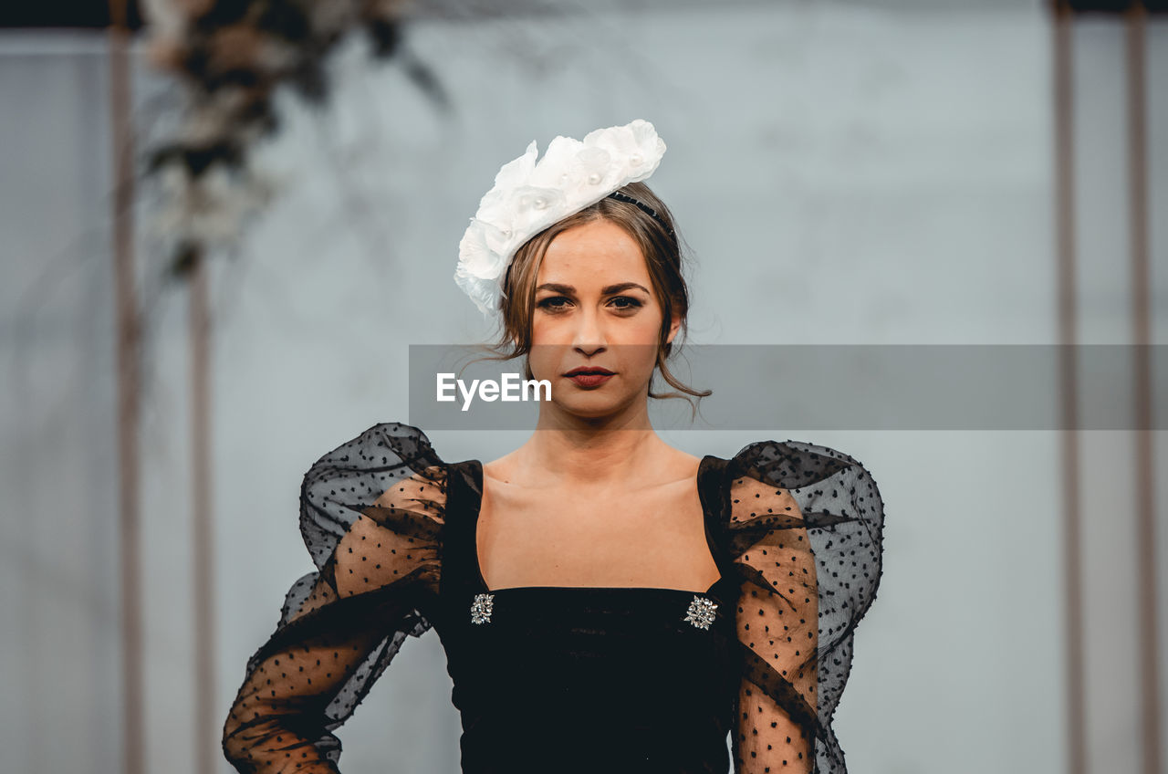 Portrait of young woman looking at camera