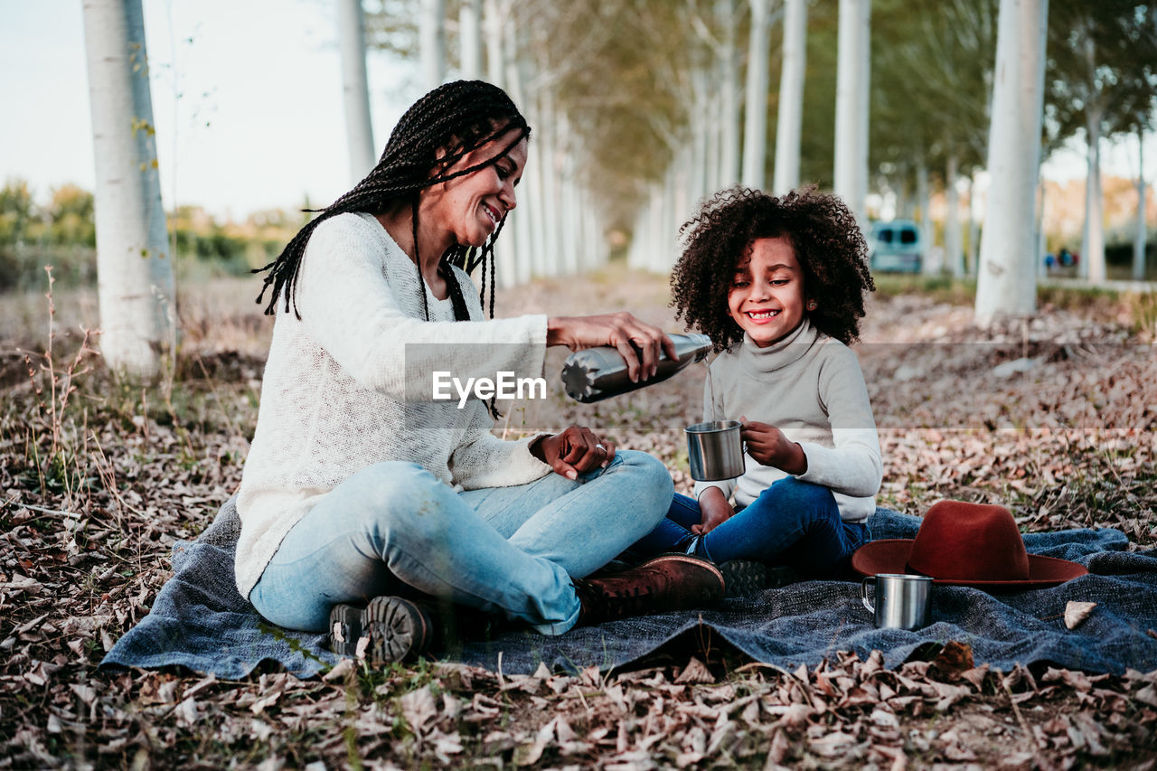 Smiling young woman sitting outdoors