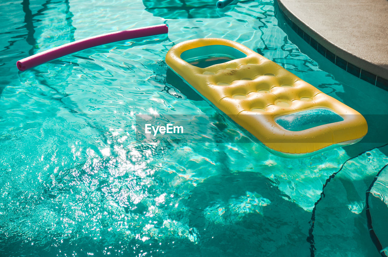 HIGH ANGLE VIEW OF YELLOW SWIMMING POOL