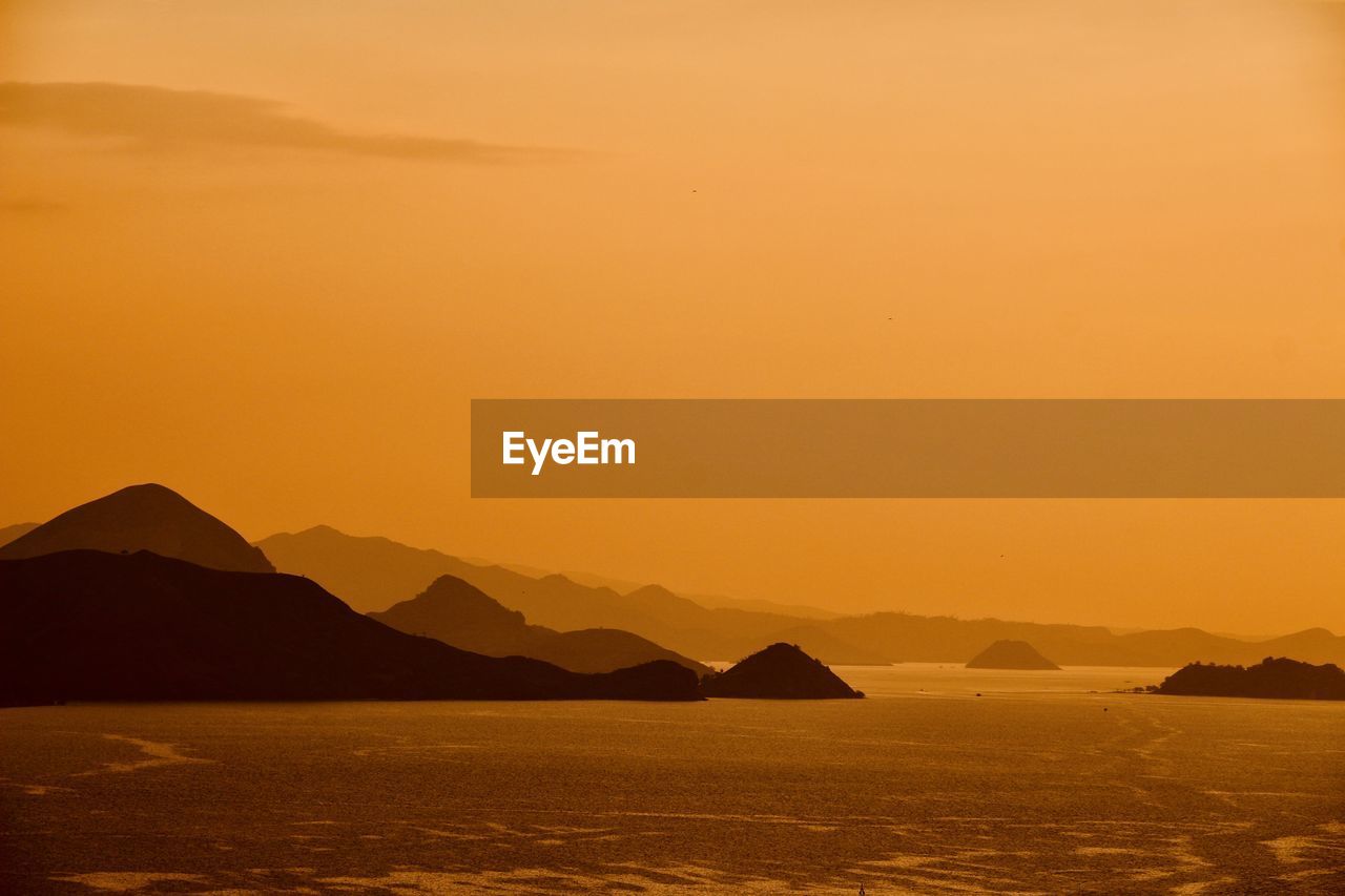 Scenic view of sea against orange sky