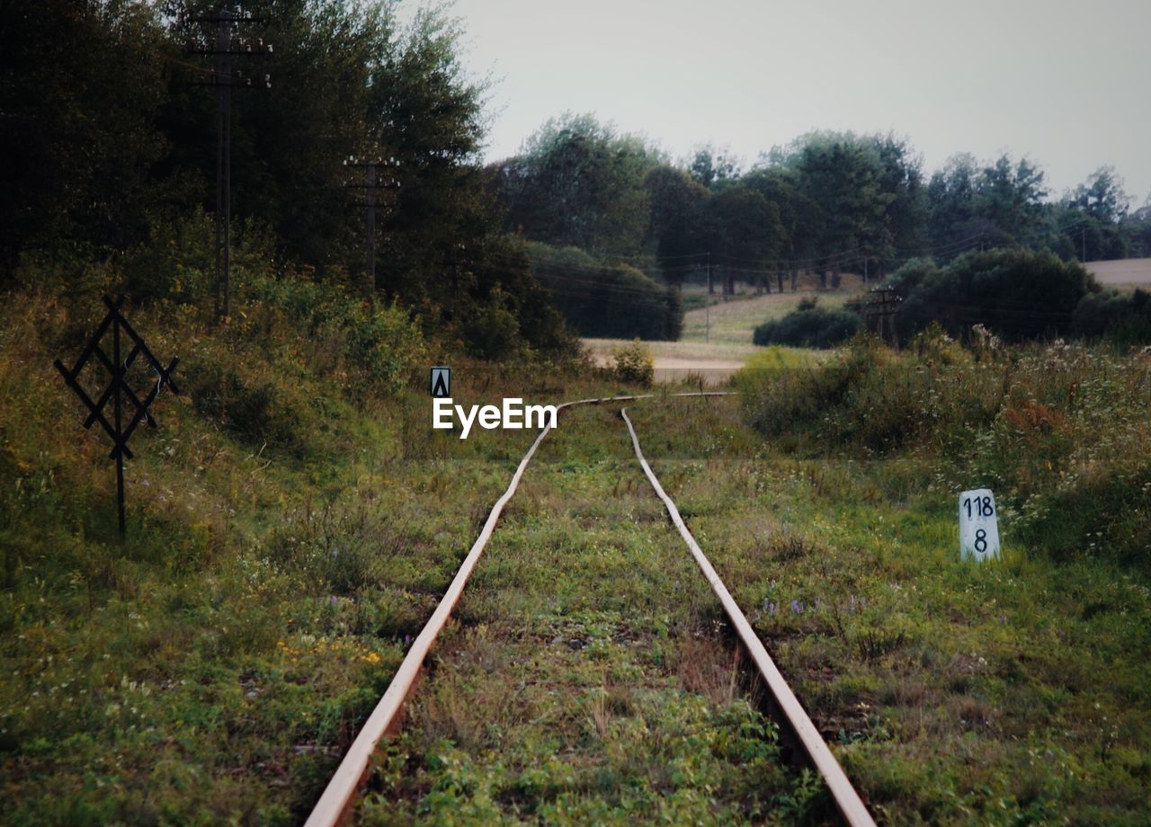 Railroad track on grassy field