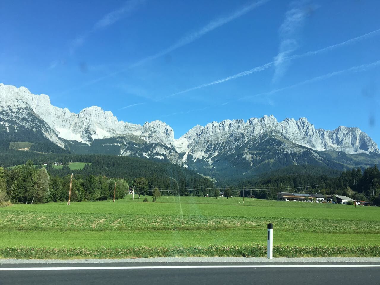 VIEW OF TREES ON LANDSCAPE AGAINST MOUNTAIN RANGE