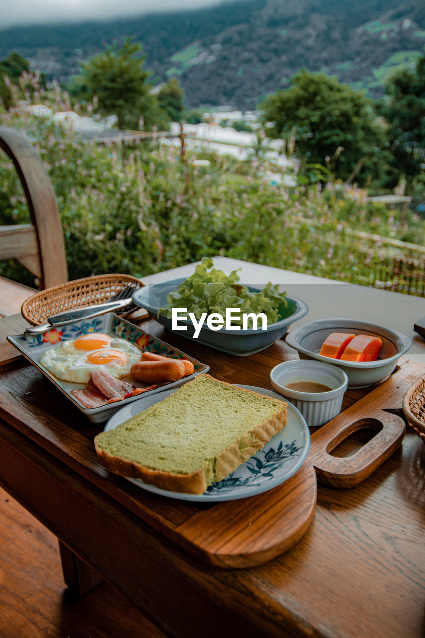 food and drink, food, healthy eating, table, meal, wellbeing, no people, tableware, plate, fruit, freshness, vegetable, dish, breakfast, bread, lunch, day, nature, landscape, drink, fast food, plant, outdoors, bowl, household equipment, wood, snack, cheese, restaurant, summer, high angle view, mountain, salad