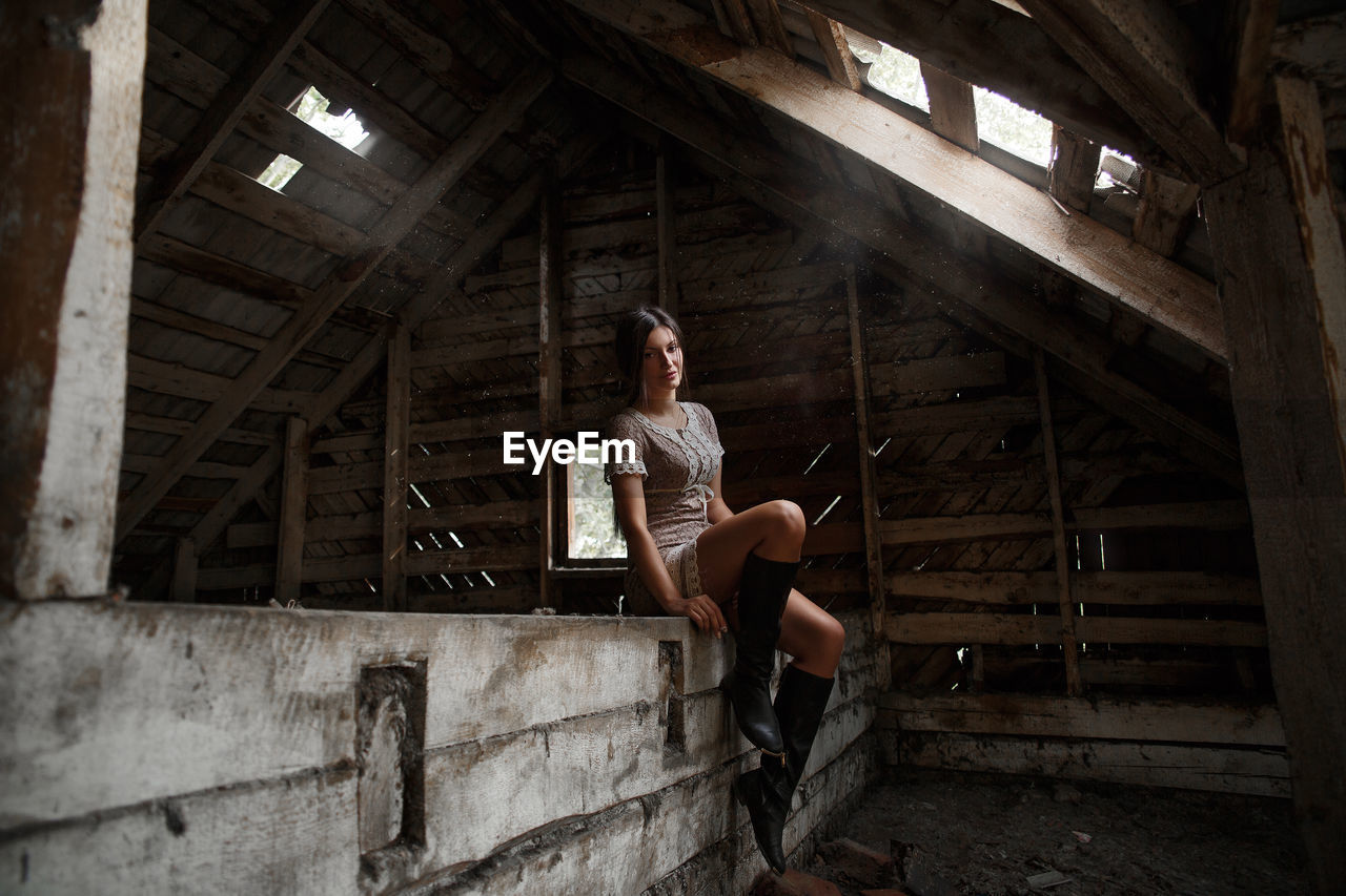 Woman sitting in abandoned building