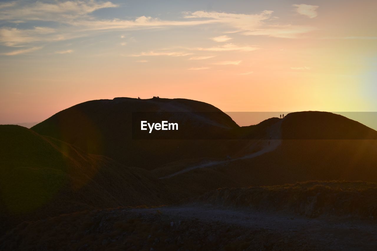 Scenic view of silhouette mountains against sky during sunset