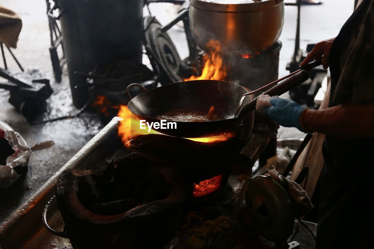 Close-up of preparing food on barbecue grill