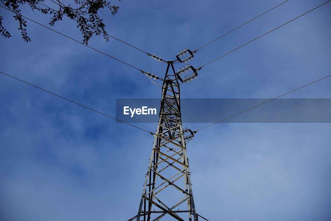 Low angle view of electricity pylon against sky