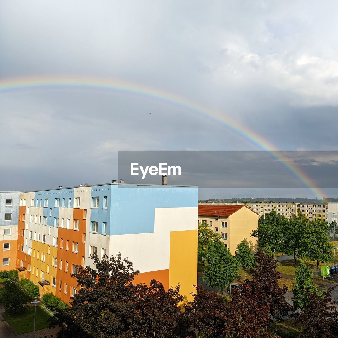rainbow, architecture, building exterior, built structure, sky, cloud, building, multi colored, city, nature, tree, plant, double rainbow, residential district, beauty in nature, no people, outdoors, day, house, scenics - nature, sunlight, environment, horizon, cityscape, skyline, neighbourhood, water, landscape, urban area