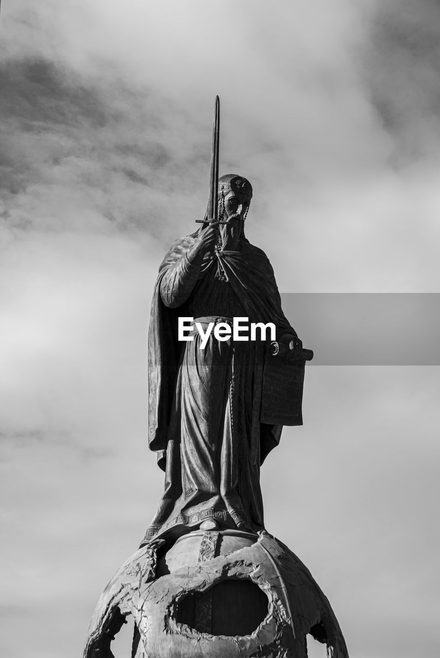 Low angle view of statue with a sword