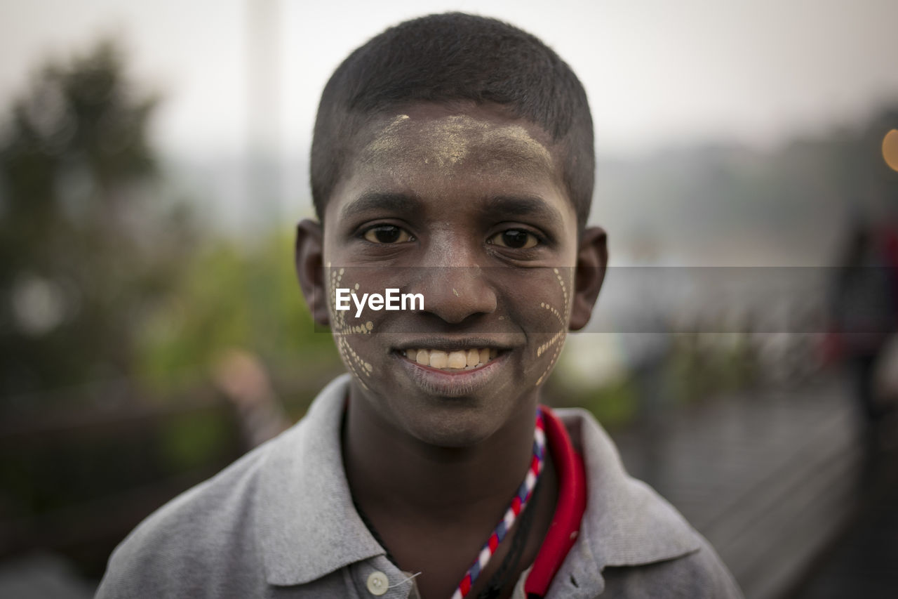 Close-up portrait of smiling boy with face paint