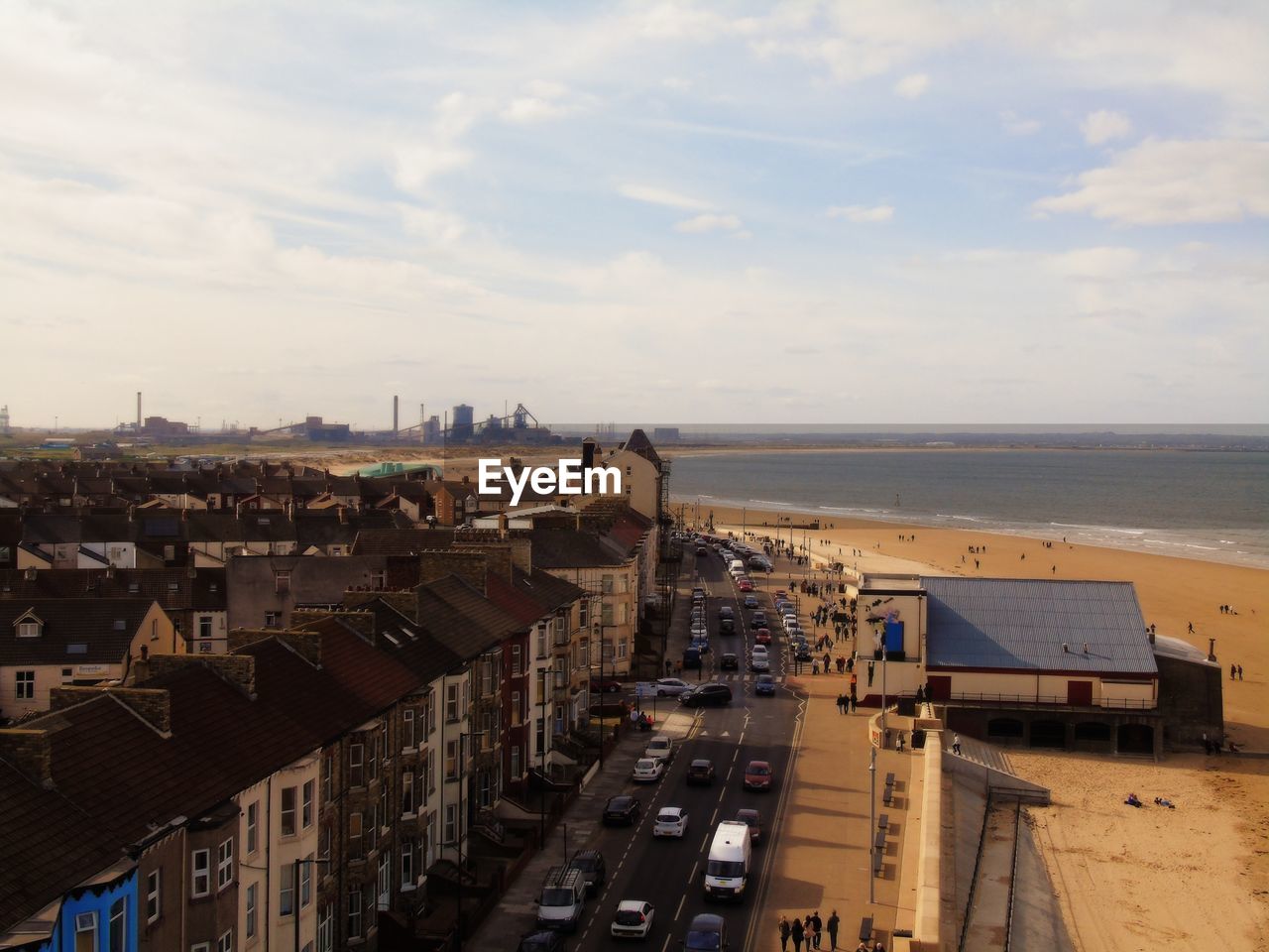 High angle view of cars on road by beach in city