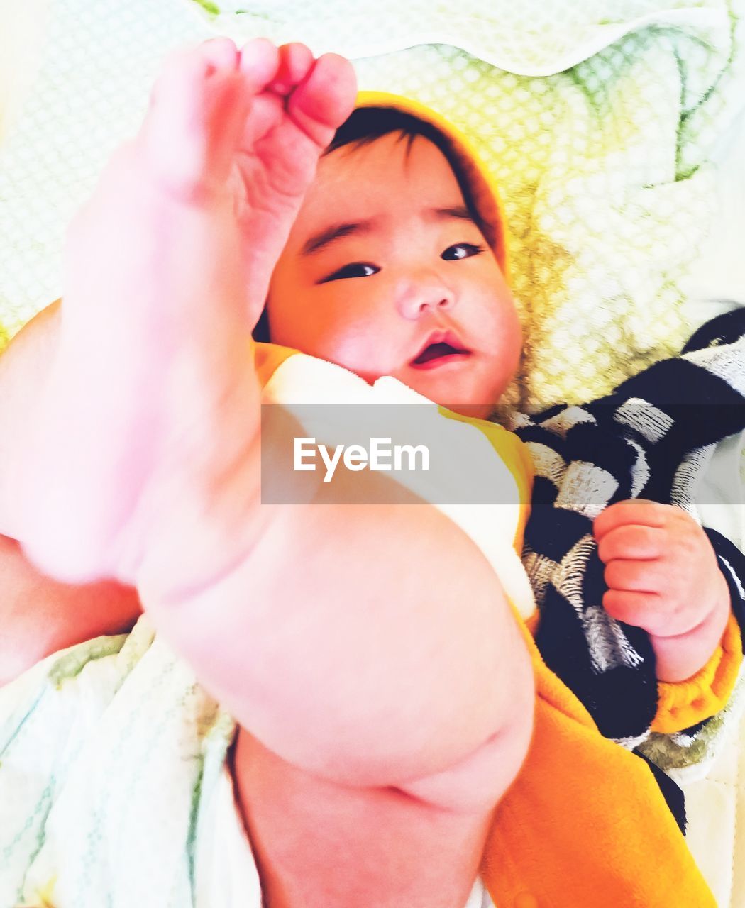 High angle portrait of cute baby girl lying at home