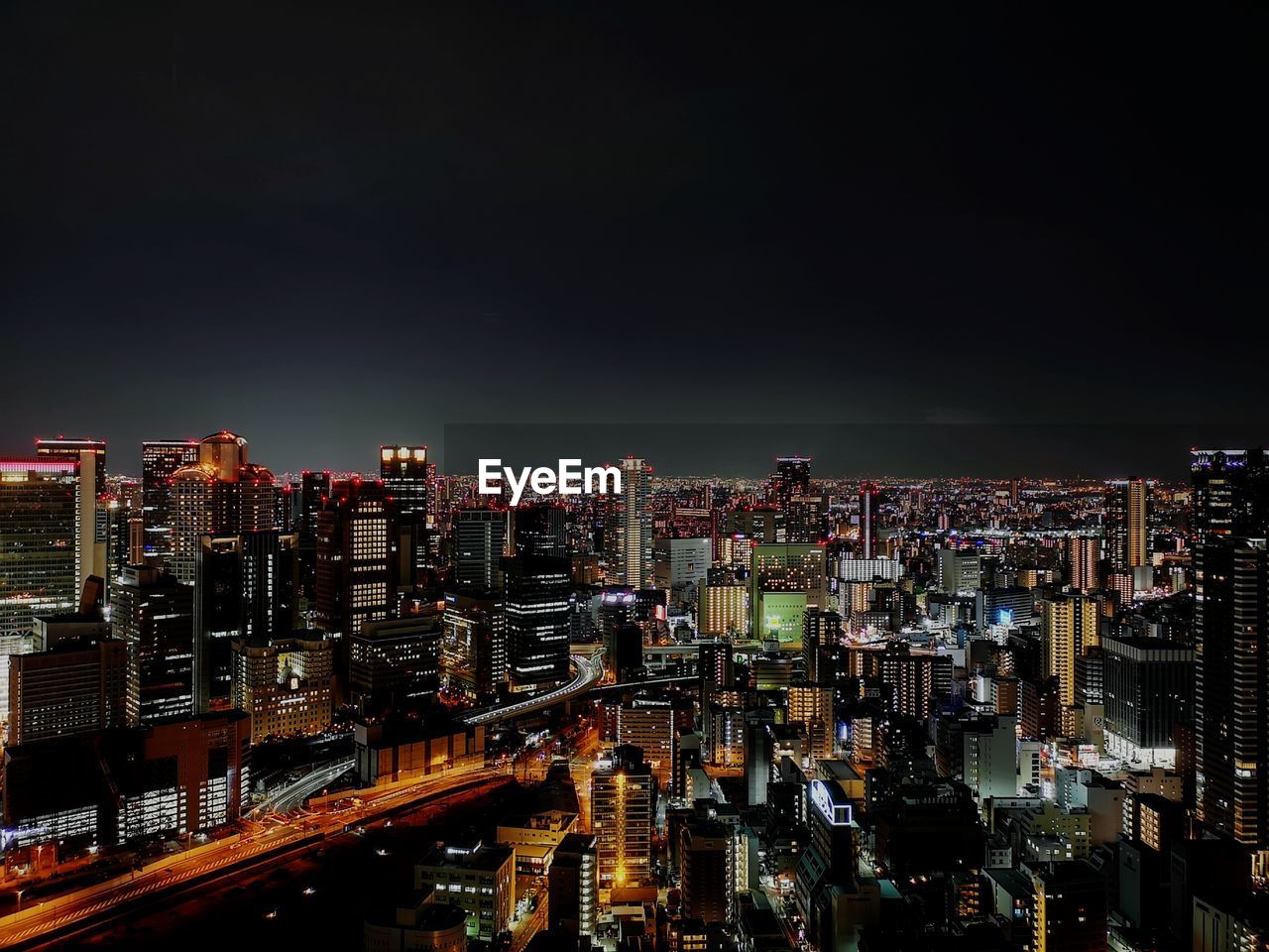 Illuminated cityscape against sky at night