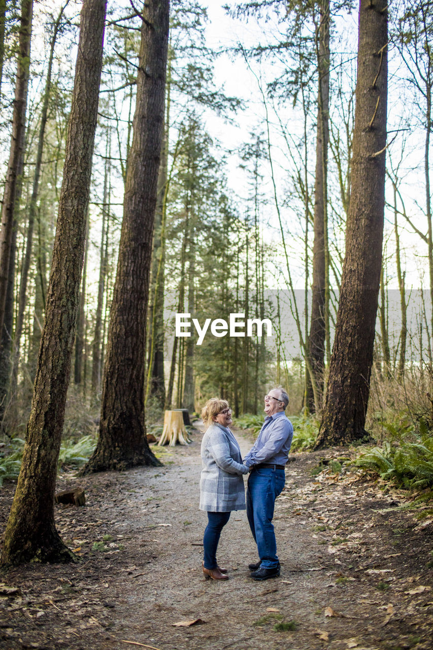 Retired couple sharing a laugh in nature