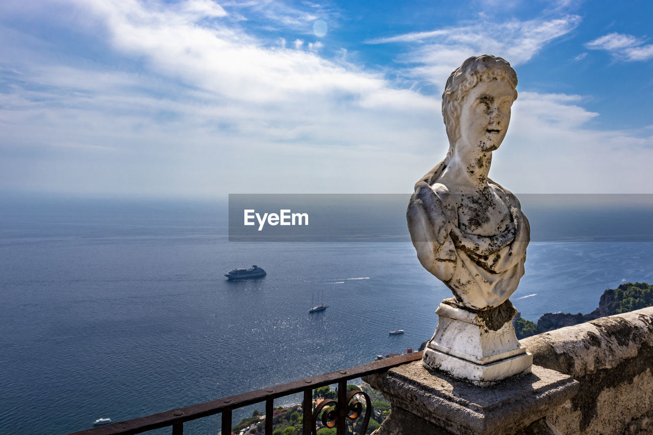 STATUE ON SEA AGAINST SKY