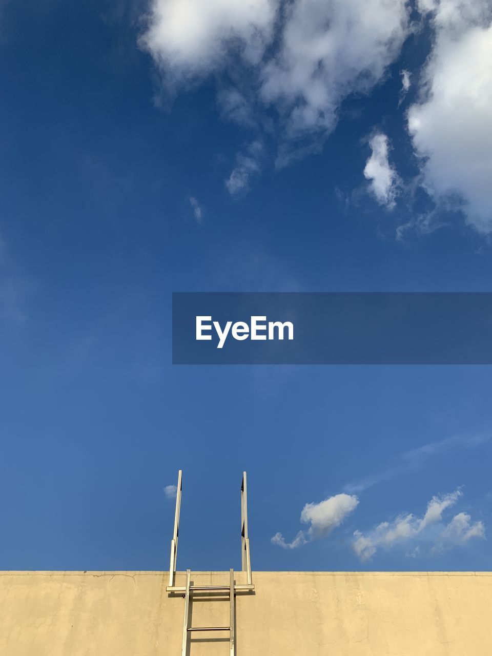 Low angle view of ladder on field against sky