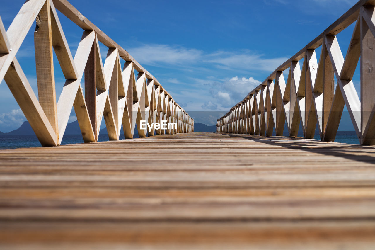 Low angle view of footbridge against sky