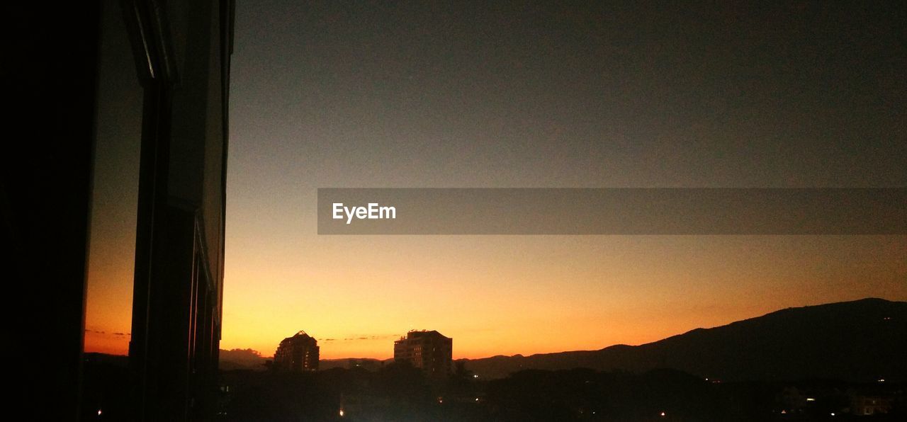 SILHOUETTE OF BUILDING AT SUNSET