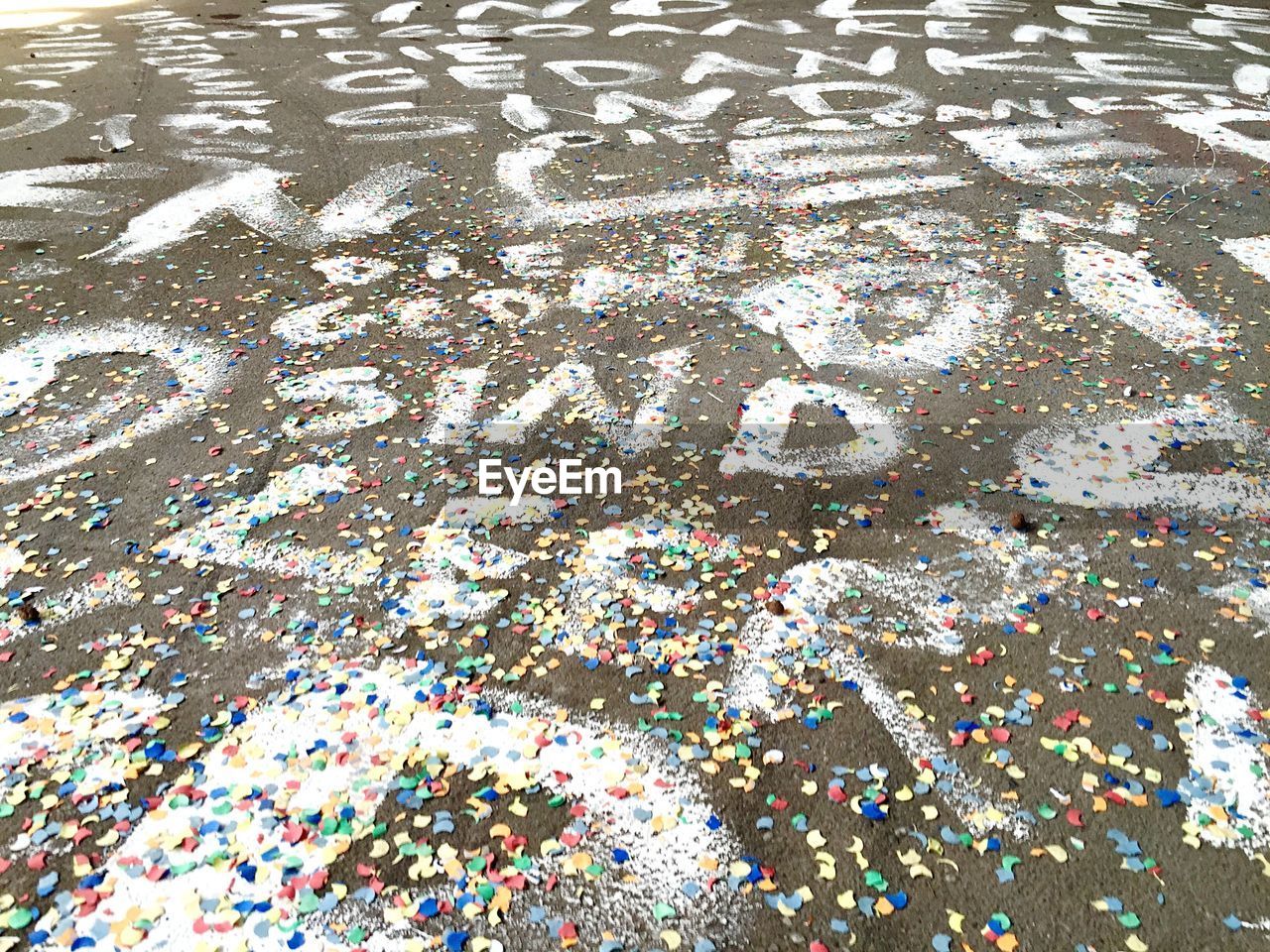 Full frame shot of spray paint street with colorful confetti