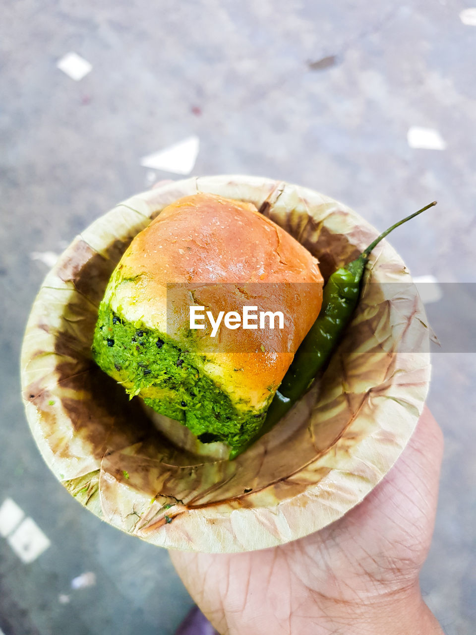 HIGH ANGLE VIEW OF PERSON HOLDING BREAD