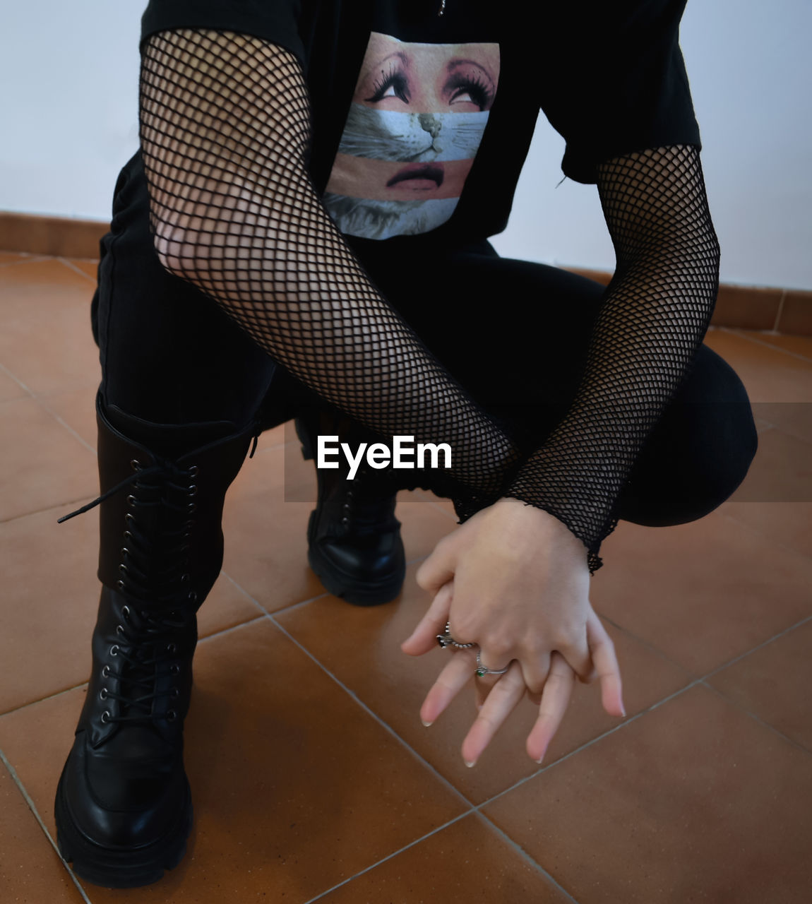 LOW SECTION OF WOMAN SITTING ON FLOOR