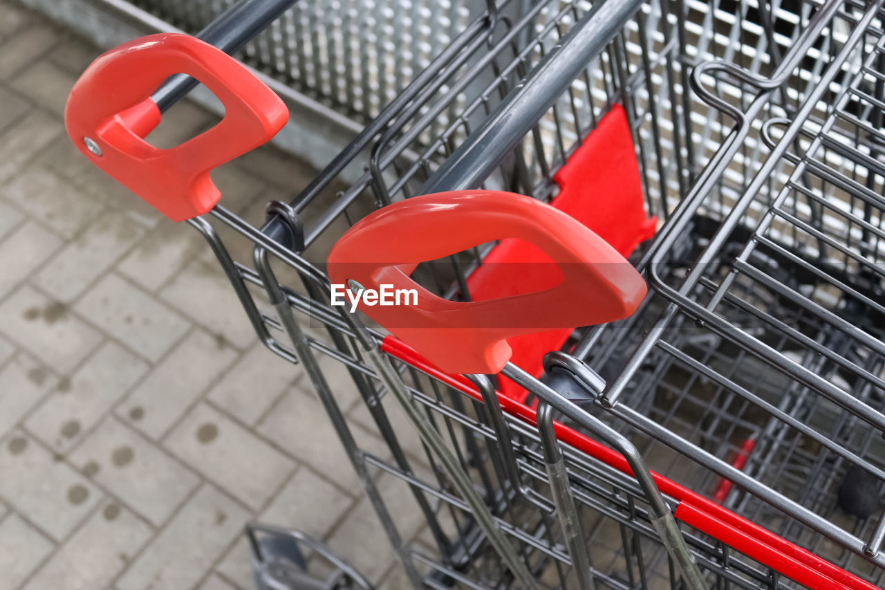 shopping cart, red, metal, shopping, cart, consumerism, no people, retail, vehicle, empty, day, outdoors