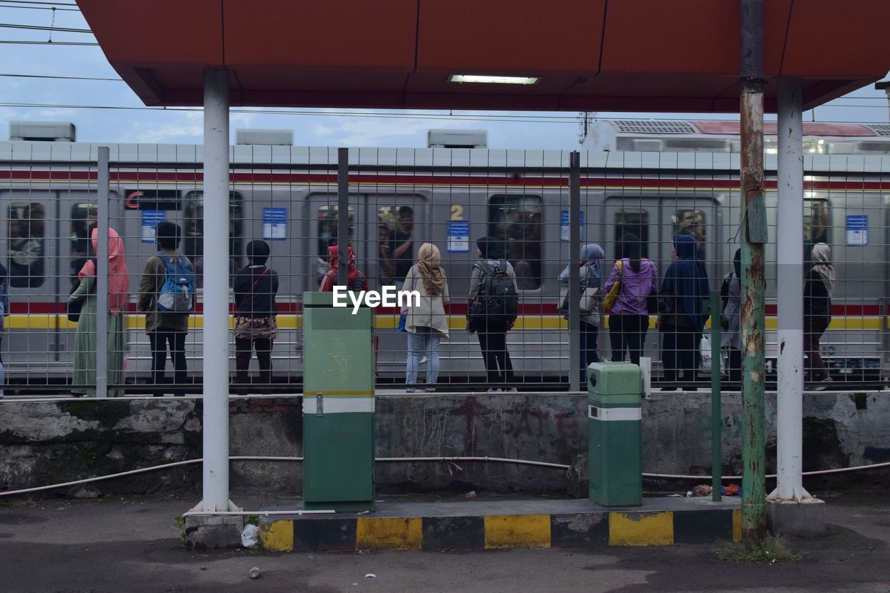 People standing on railroad station platform