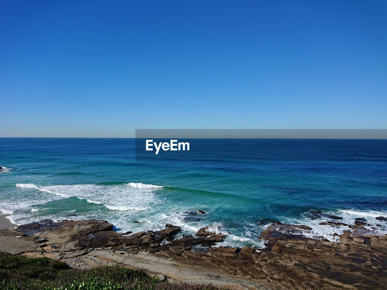 Scenic view of sea against clear blue sky