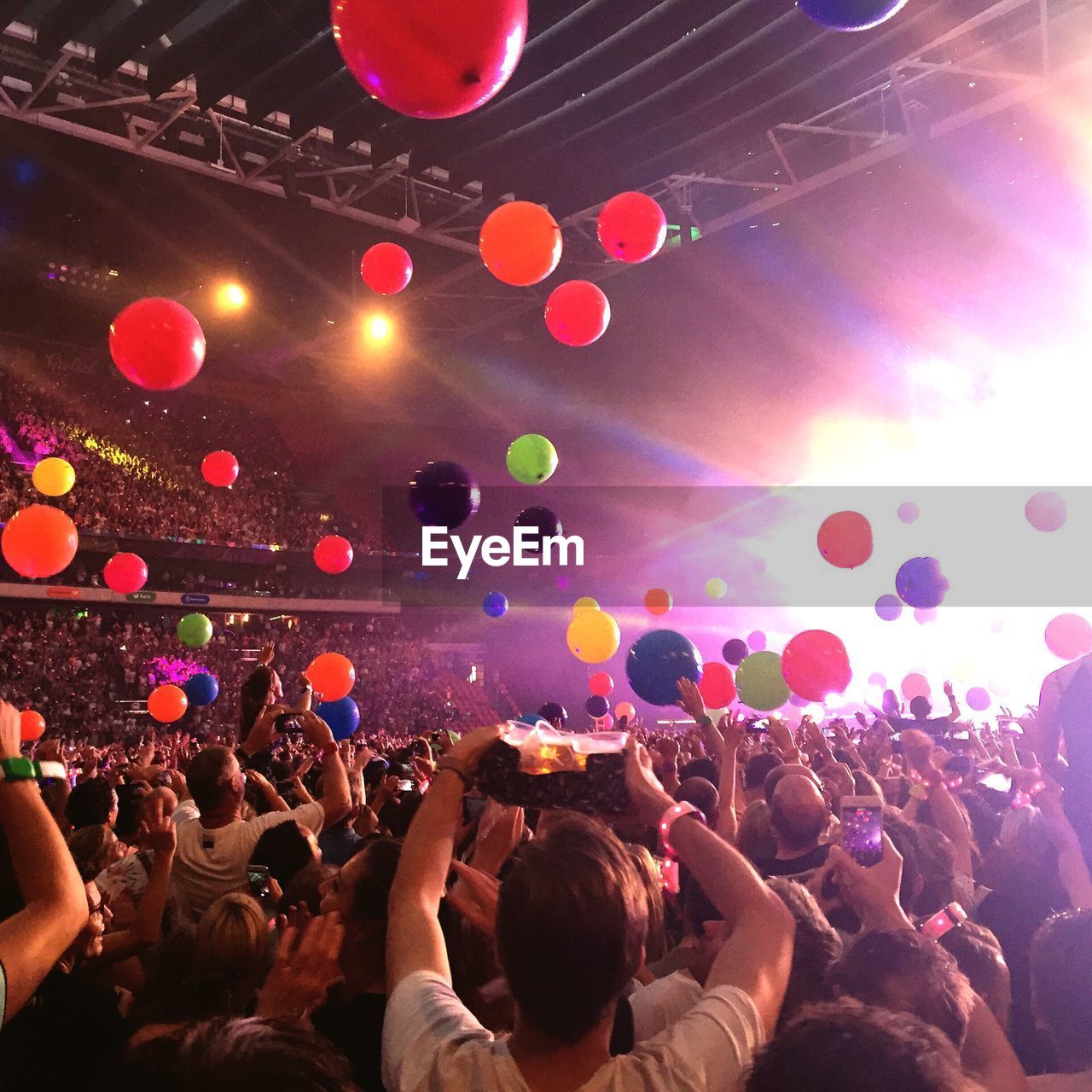 People enjoying with balloons at music concert