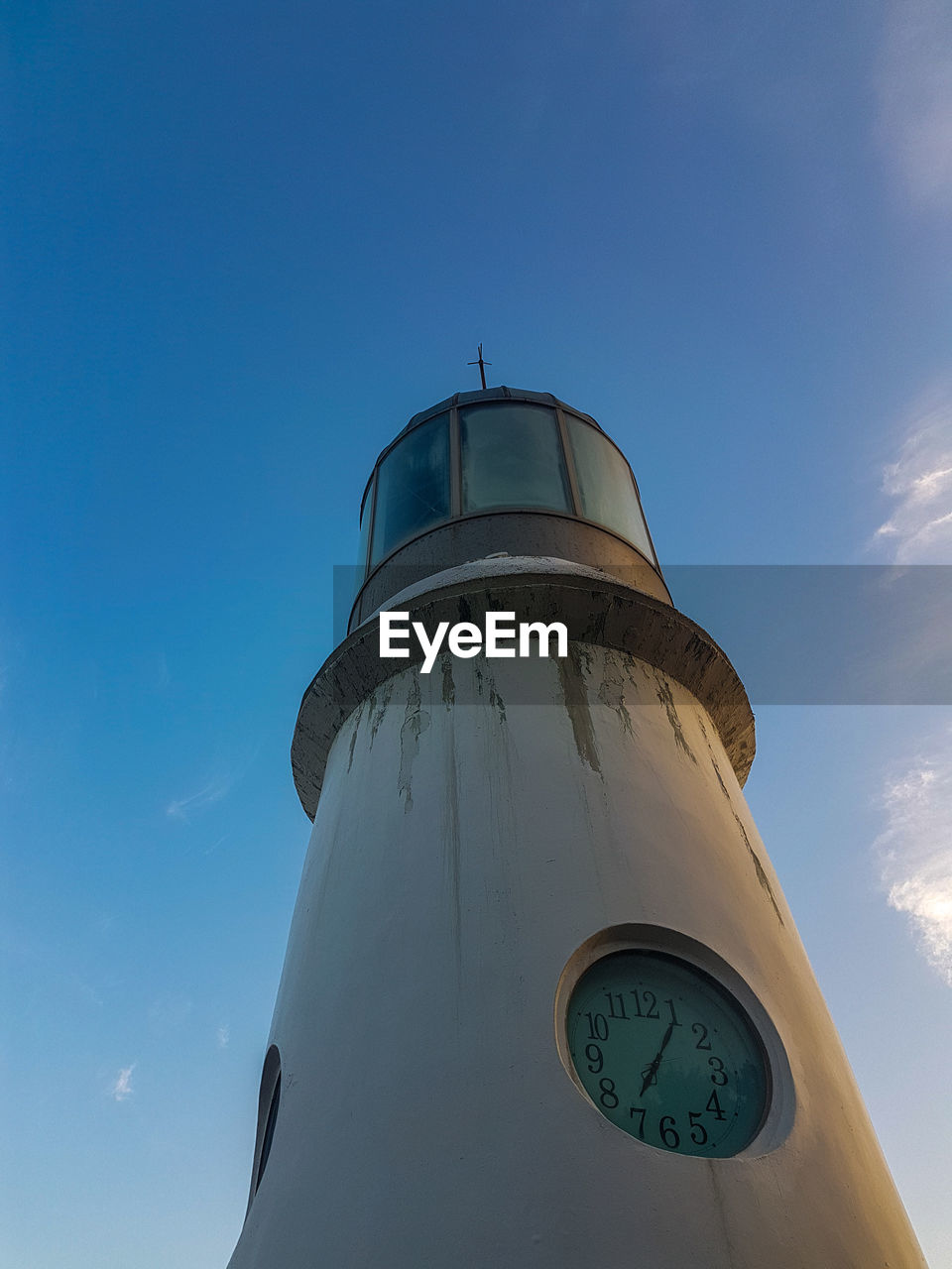 LOW ANGLE VIEW OF CLOCK TOWER BY BUILDING AGAINST BLUE SKY