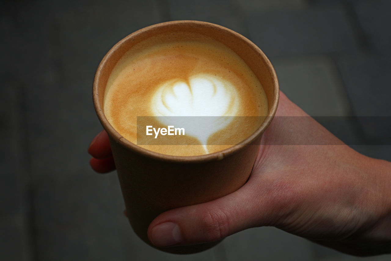 Close-up of person hand holding coffee cup